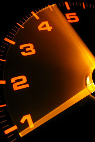 Clock yellow numbers black background - a close up of a clock free wallpaper for mobile