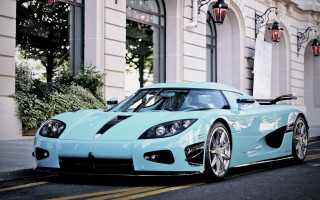 Blue sports car lightblue building - the side of the road in front free wallpaper for desktop