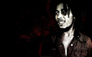 Man dreadlocks smiling camera dark - a red wall behind free wallpaper