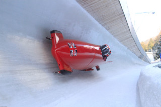 Red toy airplane snowy surface - a building and trees free wallpaper