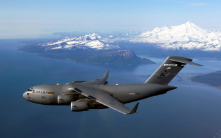 Military plane flying water mountains 2 - a large military plane free wallpaper