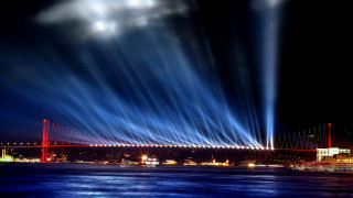 Bridge lights nighttime city background - a city in the background and a bridge in the foreground free wallpaper for desktop