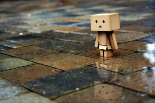 Cardboard toy sad face tiled - a puddle of water free wallpaper