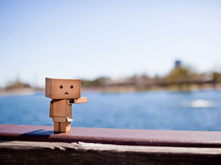 Cardboard man standing on ledge - single free wallpaper for desktop