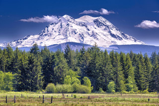 Mountain forest fence sky tilt - peak in the background free wallpaper