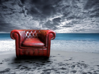 Red leather beach chair ocean - the ocean under a cloudy sky free wallpaper