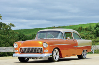 Orange white car parked street - a fence and trees free wallpaper