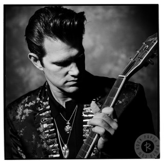 Man holding guitar serious look - free vintage wallpaper for tablet