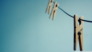 Wooden clothes pins hanging clothesline - a clothes line free wallpaper