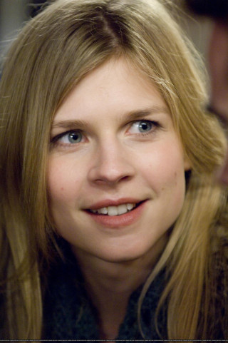 Woman blonde hair smiling man - a man in the background free wallpaper for mobile