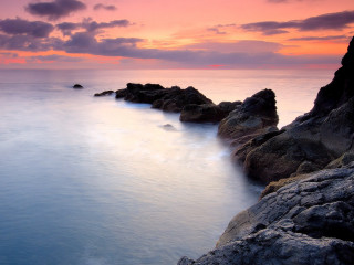 Sunset ocean rocks long exposure - a pink sky in the background free wallpaper