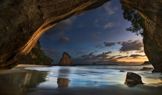 Cave entrance ocean mountains night - photo free wallpaper