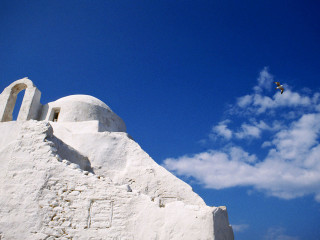 Bird flying white building blue - constantine andreou free wallpaper