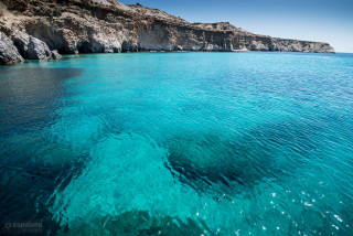 Boat blue water cliff exekias - a cliff in the background free wallpaper