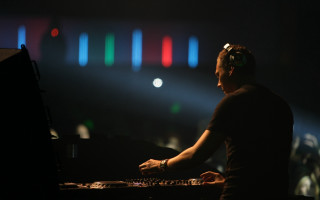 Man headphones playing keyboard dark - a spotlight free wallpaper