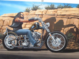 Man motorcycle rock wall desert - a painting of a man free wallpaper
