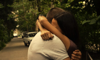 Romantic embrace street cars nature - a man and woman free wallpaper for desktop