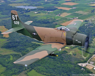Military plane flying lush green - a small town free wallpaper