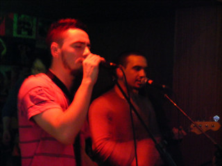 Man singing microphone guitar dark - another man free wallpaper