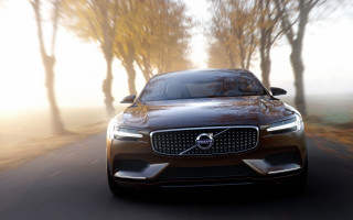 Volvo car driving road trees - foggy sky above free wallpaper