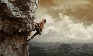 Man climbing mountain sky background - extreme illustration free wallpaper