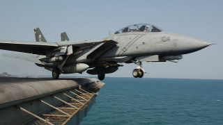 Fighter jet flying over water - the side of the ship free wallpaper