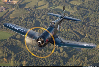 Small airplane flying lush green - a yellow circle free wallpaper