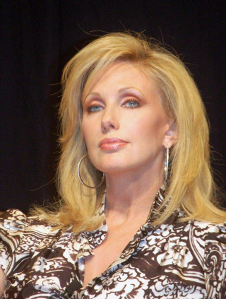 Blonde haired woman serious look - shirt free wallpaper for mobile