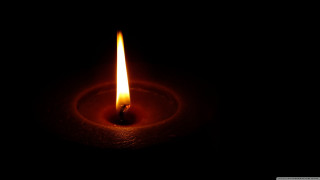 Lit candle dark black background - free light wallpaper for desktop