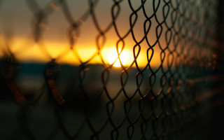 Sunset chain link fence building - mesh wire free wallpaper