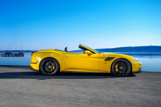 Yellow sports car water dock 2 - the side of a road near a body of water free wallpaper