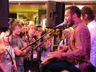 Man singing microphone group watching - free happy birthday wallpaper