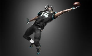 Football player air ball helmet 4 - his hand and a helmet free wallpaper