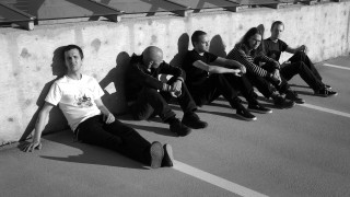 Group sitting wall feet up - one person free wallpaper