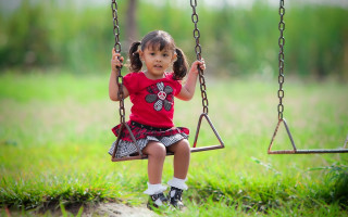 Little girl swing park grass - orphism free wallpaper