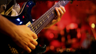 Guitarist red background blurry lights - a person playing free wallpaper