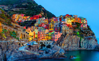 Colorful village cliff water night - vibrant free wallpaper