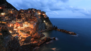 Village cliff ocean nighttime lights - a village free wallpaper for desktop