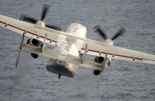 Propeller plane ocean cloudy day - the front of the plane free wallpaper