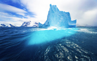 Iceberg floating ocean blue sky 2 - an iceberg free wallpaper