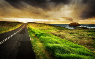 Lush green ocean road cloudy - the ocean under a cloudy sky free wallpaper