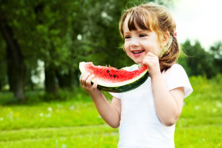 Little girl eating watermelon field - little free wallpaper