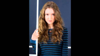 Woman thumbs up blue wall - a thumb free wallpaper