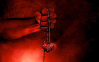 Hand holding heart shaped pendant - dark art free wallpaper