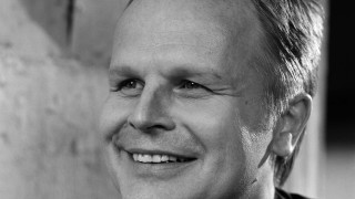 Man tie suit smiling camera 2 - a wall behind free wallpaper