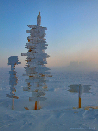 Pole signs snow sky building - free winter wallpaper for mobile