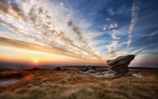 Rock formation grassy field sunset - volumetric light free wallpaper