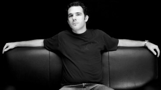 Man sitting couch arms crossed 4 - studio portrait free wallpaper for desktop