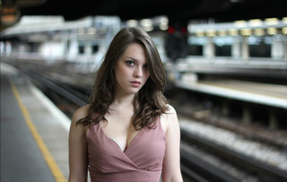 Woman pink dress train station - a train in the background free wallpaper