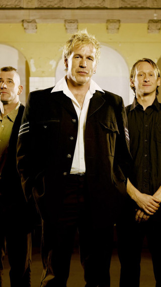 Men standing bauhaus building clock - a group of men free wallpaper for mobile